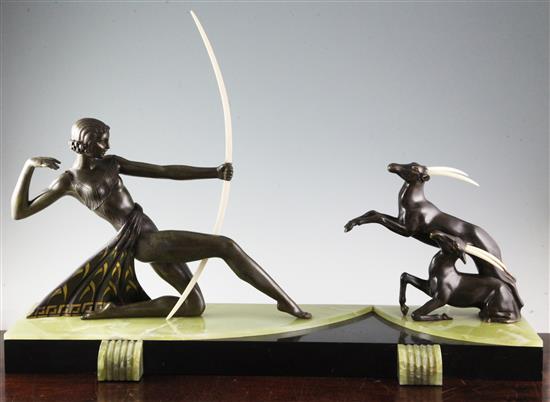 Attributed to Uriano. An Art Deco bronzed spelter and ivory group of Diana The Huntress and two gazelles, length 31in.